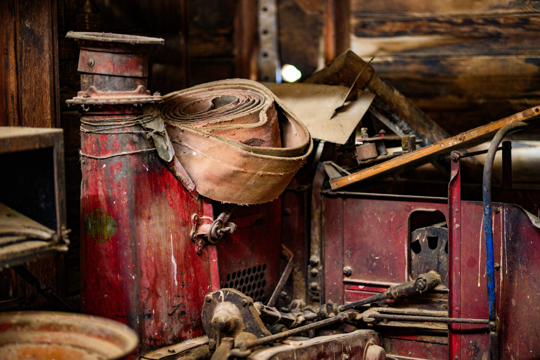 Weathered hoses and equipment coiled in the homestead workshop