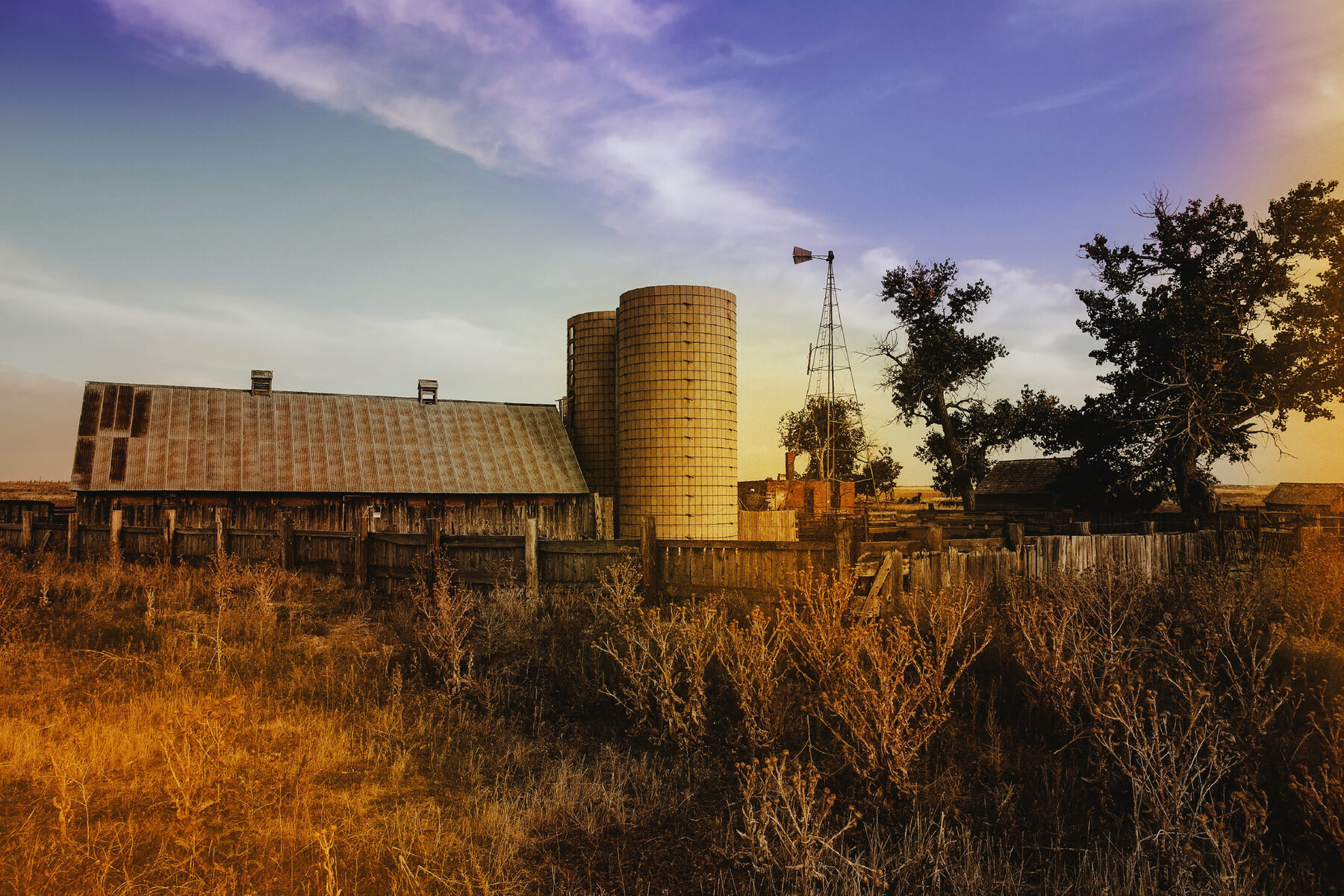 The homestead's grain silos against a dusk sky